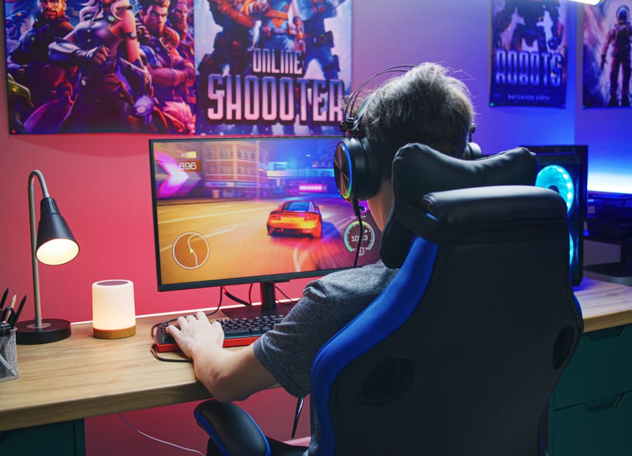 Gamer at a neon battlestation playing