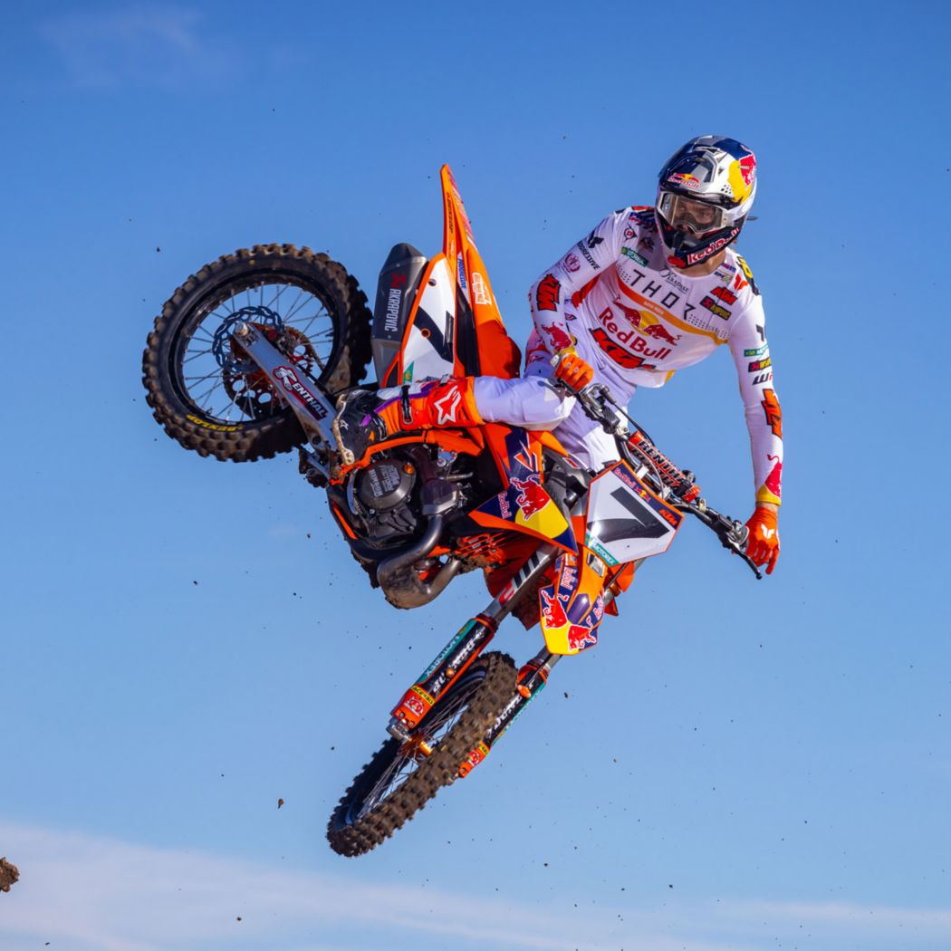 Supercross rider whipping the bike mid-air
